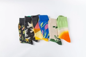 Close-up of patterned cotton crew socks featuring floral and bird artistic prints