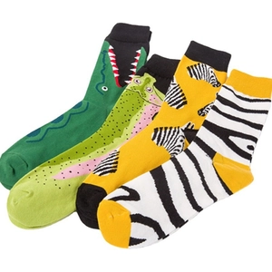 Set of four colorful crew socks featuring playful animal patterns like crocodile and zebra