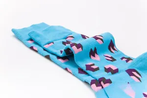 Detailed texture of blue cotton socks with colorful pink and purple heart patterns