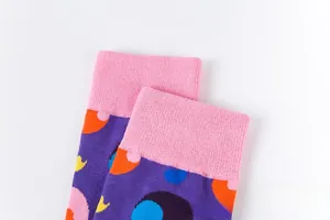 Détail de chaussettes en maille avec base violette et motifs à pois abstraits colorés
