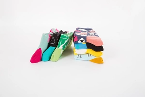 Detail of assorted colorful patterned crew socks with floral and polka dot knit designs