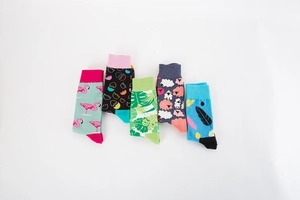 Flat lay of colorful crew socks featuring flamingo and palm leaf patterns on white background