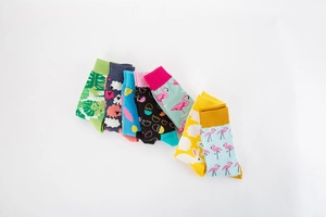 Macro shot of colorful knit socks with tropical plants flamingos and rabbits patterns