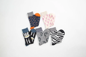 Detail of five-pair colorful cotton socks set with vibrant fun patterns and ribbed cuffs