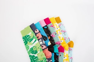 Detail of colorful mid-calf socks set with monstera leaf, flamingo, and abstract prints