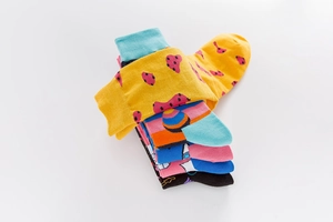 Detail view of colorful patterned crew socks with assorted vibrant cotton designs