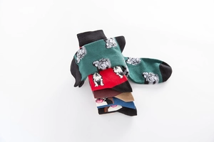 Detail of colorful cotton socks with cartoon dog patterns in five assorted colors