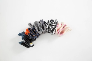 Detail view of colorful patterned cotton socks in polka dots and stripes on white background