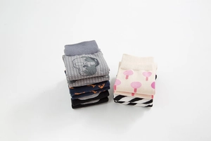 Flat lay of colorful cotton socks with skull, mushroom, anchor, and stripe patterns