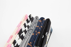 Detail of stacked cotton socks showing assorted patterns like stripes and dots