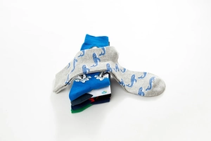 Detail of assorted crew socks featuring colorful cartoon whale and shark ocean patterns