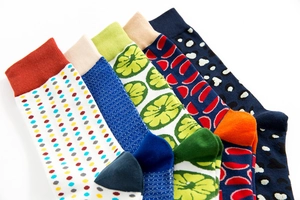 Detail of colorful patterned cotton mid-calf socks with ribbed cuffs and neat knit textures