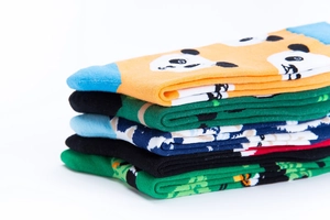 Detail view of five pairs of colorful cotton crew socks featuring cute panda patterns