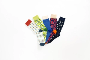 Set of five vibrant patterned cotton mid-tube socks with dots and geometric designs
