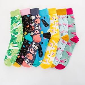 Set of 7 colorful crew socks featuring tropical leaves, flamingo, and rabbit patterns