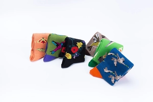 Flat lay of cotton crew socks featuring floral, butterfly, and bird patterns in various colors