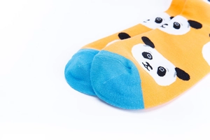 Detail view of cotton socks with cute panda pattern and contrasting blue toe design