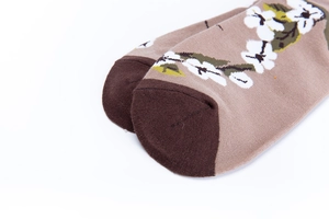 Close-up of floral cotton mid-calf socks showing toe stitching and brown flower print