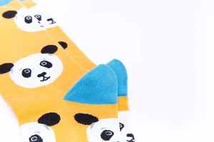 Close-up of orange panda cotton socks with blue heel detail and knitted pattern