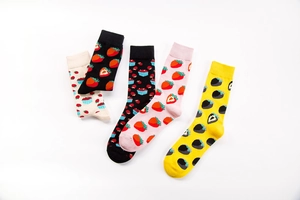 Flat lay of five pairs of cotton crew socks featuring cute various strawberry patterns