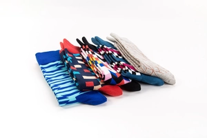 Detail of assorted crew socks with colorful geometric patterns and cotton knit texture