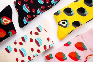 Detail shot of cotton crew socks featuring cute strawberry patterns in assorted colors