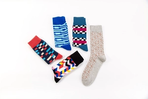 Detail of five crew socks showing various geometric patterns and ribbed elastic cuffs