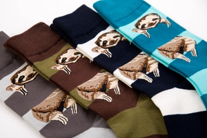 Detail view of 4-pack cotton crew socks featuring cute sloth patterns and striped designs