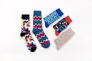 Close-up of five pairs of cotton mid-calf socks with colorful geometric patterns