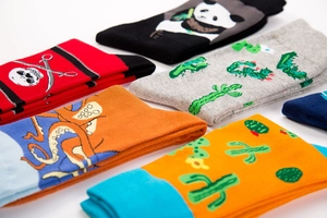 Detail shot of mid-calf cotton socks with cartoon panda and octopus knitted patterns