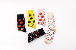 Flat lay of five cotton crew socks with varied strawberry patterns in pink and yellow