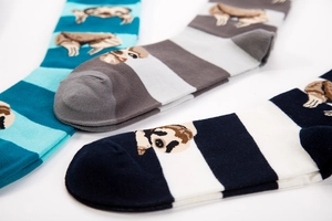 Three pairs of striped knitted mid-calf socks with cute cartoon sloth patterns