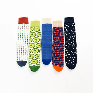 Five pairs of colorful crew socks with dots, fruit, and geometric patterns in cotton blend