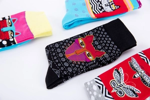 Detailed view of colorful knit cotton socks with artistic cat and butterfly patterns