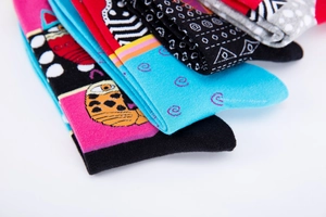 Close-up of colorful knitted cotton socks featuring cat patterns and leopard prints