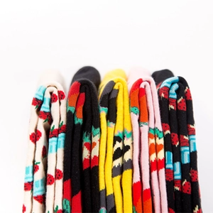 Colorful cotton socks with strawberry patterns and striped cuffs in a stacked arrangement