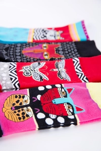 Set of four colorful mid-calf socks with vibrant cat and butterfly pop art patterns