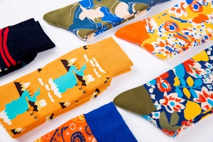 Detailed close-up of cotton socks featuring landscape patterns and vintage floral designs