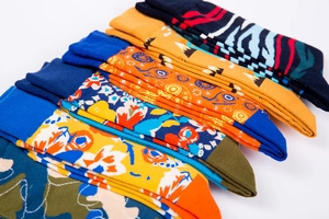 Close-up of vibrant knitted socks with colorful abstract patterns and ribbed cuffs