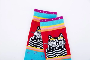 Detailed close-up of artistic cat pattern and colorful stripes on knitted socks