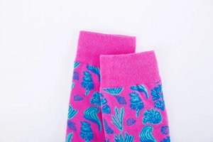 Détails des bords-côtes sur chaussettes roses en coton avec motifs corail bleus