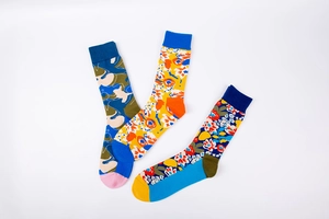 Detailed view of colorful abstract camouflage and floral patterns on ribbed cotton socks
