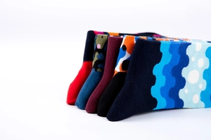 Macro view of assorted knitted cotton crew socks in vibrant patterns and solid colors