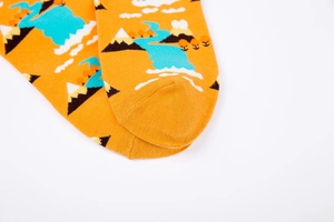 Close-up of the reinforced toe and scenic nature pattern on the orange knitted cotton sock
