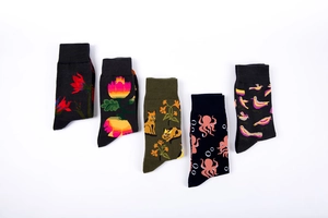 Set of five cotton socks featuring dark floral and animal patterns in a wave layout