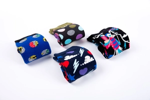 Detail of four pairs of cotton crew socks with colorful bird and abstract geometric patterns