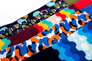 Detail of colorful leopard and geometric patterned cotton crew socks for men and women