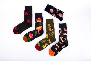 Detail of cotton crew socks featuring dark floral and animal patterns with ribbed cuffs
