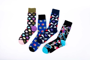 Detail view of 4 pairs of cotton blend crew socks with geometric and floral patterns
