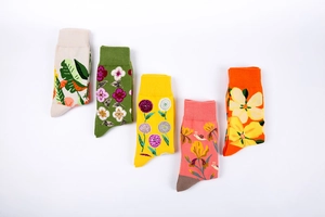 Detailed view of five pairs of cotton socks featuring colorful floral and garden patterns